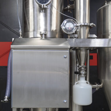 Detailed view of an industrial spray dryer system from Pulse Combustion Systems, showcasing the stainless steel construction and advanced spray drying equipment components.
