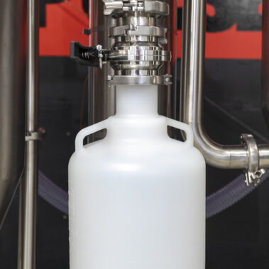 Powder collection container attached to the sanitary valve of an industrial spray dryer, part of a complete spray drying system by Pulsedry.com.