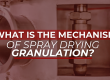Close-up of spray drying equipment with overlaid question: 'What is the mechanism of spray drying granulation?' in bold red and white typography.